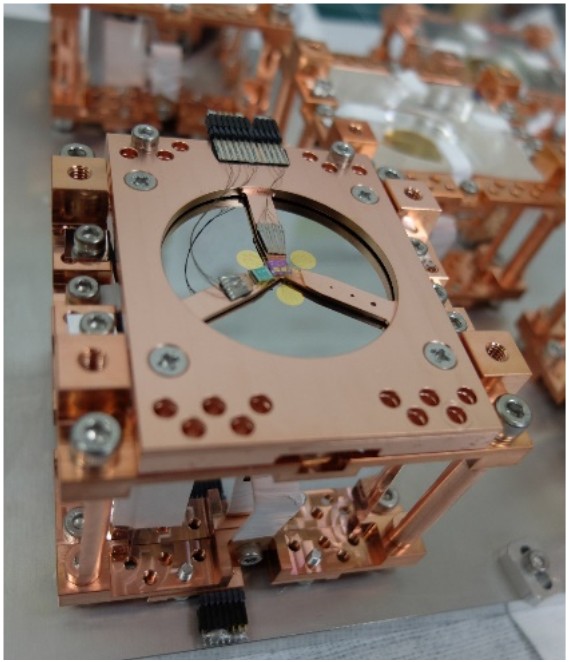 An assembled copper frame for a single detector module, designed to secure the Li2MoO4 crystals and sensors that will operate in a sub-K (~10 mK) cryogenic environment.
